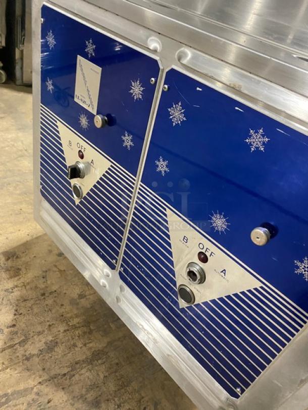 ColdElite UF820-2 stainless steel soft serve machine, twin/twist setup, 208V, 3 phase, on casters, with decorative blue panels.