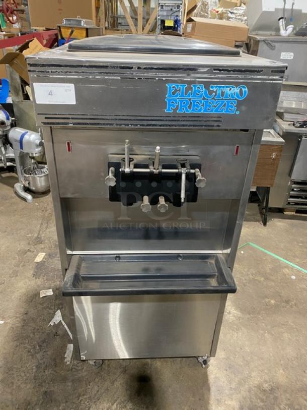 Electro Freeze stainless steel soft serve machine with twin/twist options, 2 hoppers, 3 dispensers, and casters.