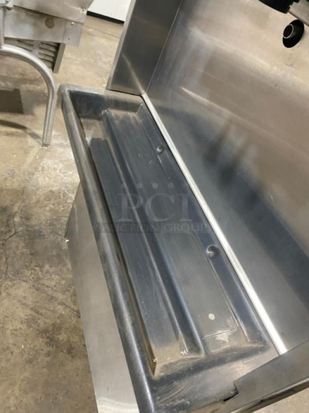 Electro Freeze stainless steel soft serve machine with twin hoppers, three dispensers, on casters. Used condition.