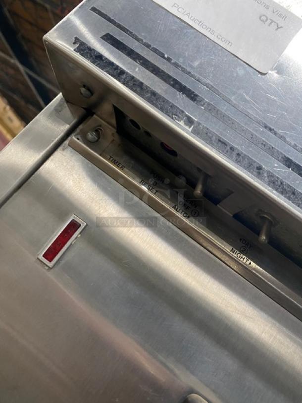 Electro Freeze stainless steel twin/twist soft serve machine, electric powered, 2 hoppers, 3 dispensers, on casters.