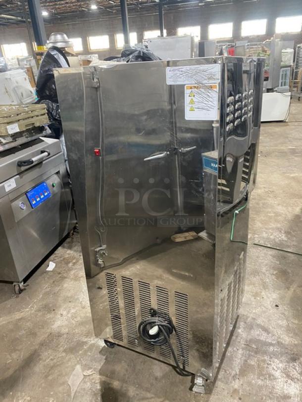 Elvaria Model 515 stainless steel soft serve machine with twin hoppers, three dispensers, on casters, 220-240V in used condition.