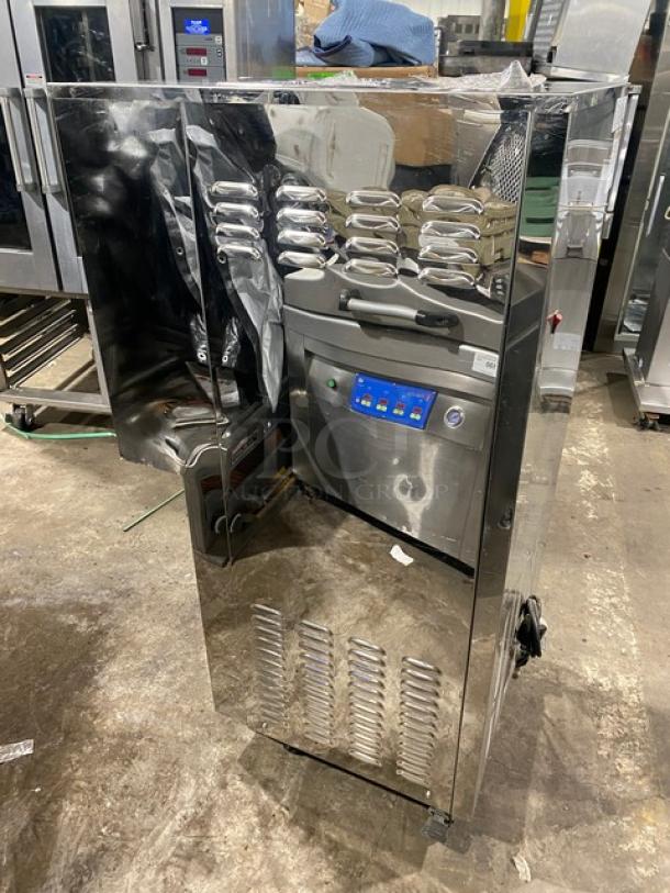 Elvaria Model 515 stainless steel soft serve machine with twin hoppers, three dispensers, digital controls, and caster wheels.