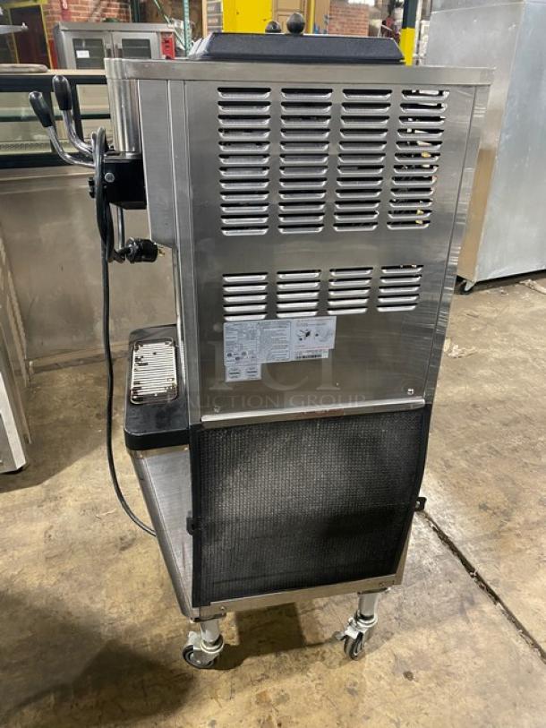 Well Spring SSI143S stainless steel soft serve machine with twin hoppers, three dispensers, digital controls, and casters.