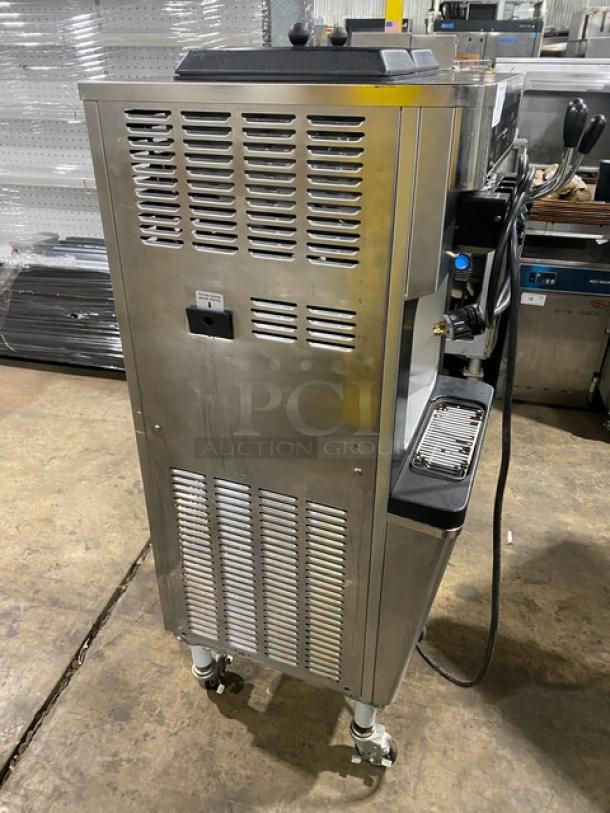 Well Spring SSI143S stainless steel soft serve machine, digital controls, 2 hoppers, 3 dispensers, drip tray, on casters.