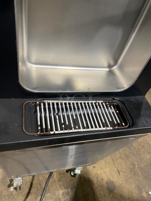 Well Spring SSI143S stainless steel soft serve machine, twin hoppers, three dispensers, drip tray, digital controls, on casters.