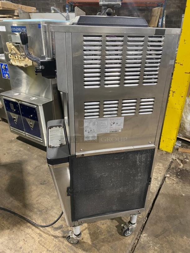 Well Spring SSI-143S stainless steel soft serve machine with 2 hoppers, 3 dispensers, drip tray, digital controls, on casters.