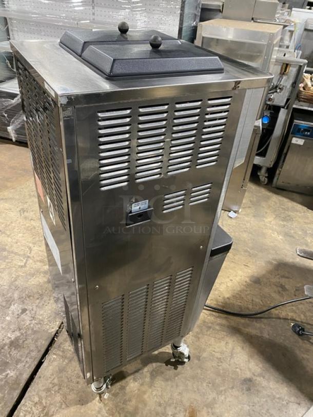 Well Spring SSI-143S stainless steel soft serve machine with 2 hoppers, 3 dispensers, drip tray, digital controls, on casters.