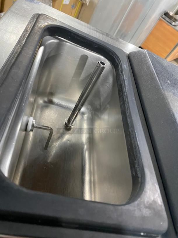 Well Spring SSI-143S stainless steel soft serve machine hopper, shown inside with metal components, indicating commercial-grade use.