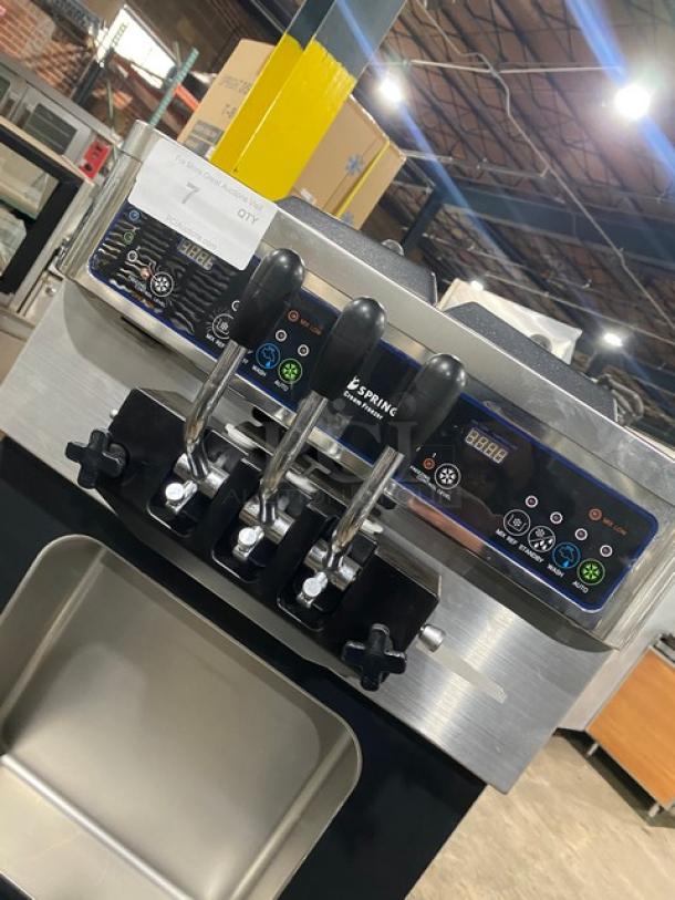 Well Spring SSI-143S stainless steel soft serve machine, 2 hoppers, 3 dispensers, digital controls, on casters, good condition.
