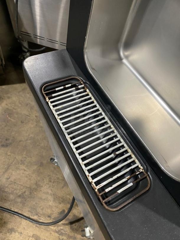 Well Spring SSI-143S stainless steel ice cream machine, features visible: drip tray, durable build, on casters.