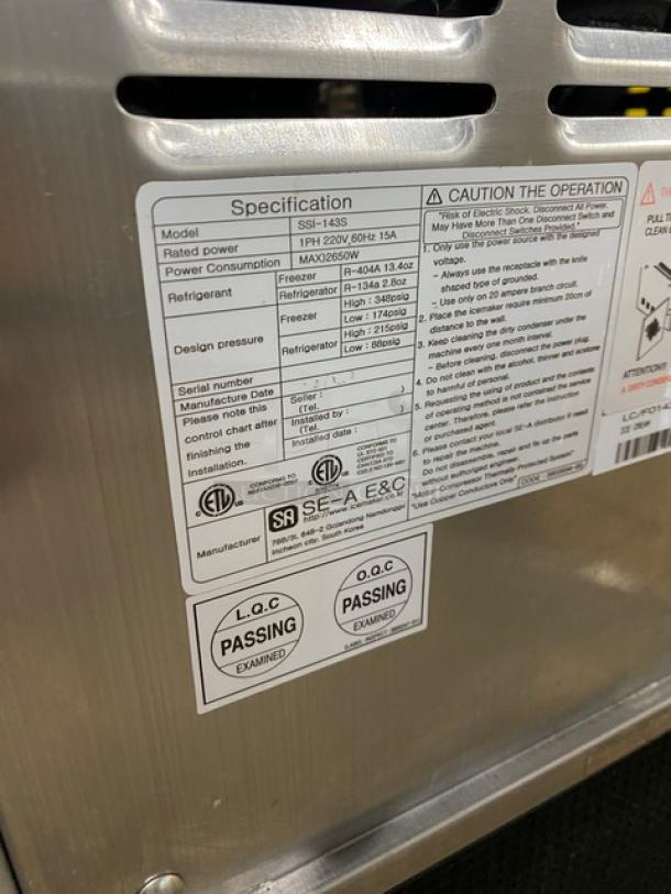 Well Spring SSI143S stainless steel twin twist soft serve machine with 2 hoppers, 3 dispensers, digital controls, and casters.