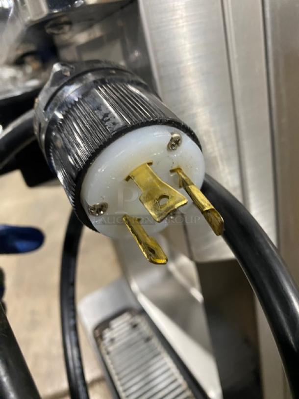 Close-up view of the Well Spring ice cream machine power plug. Three-prong 220V connection with visible wiring detail.