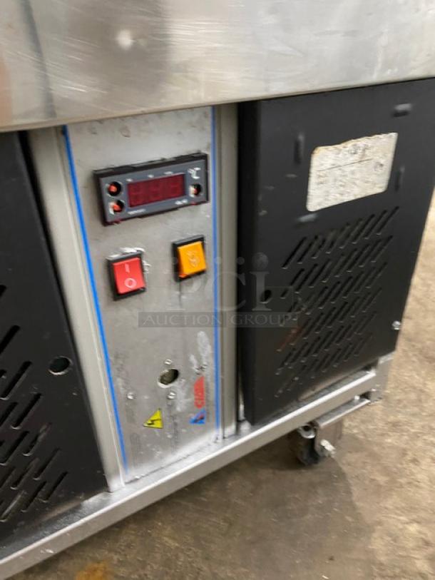 Stainless steel 10-pan gelato/ice cream case with rear sliding door, on casters. Features control panel with buttons and display.