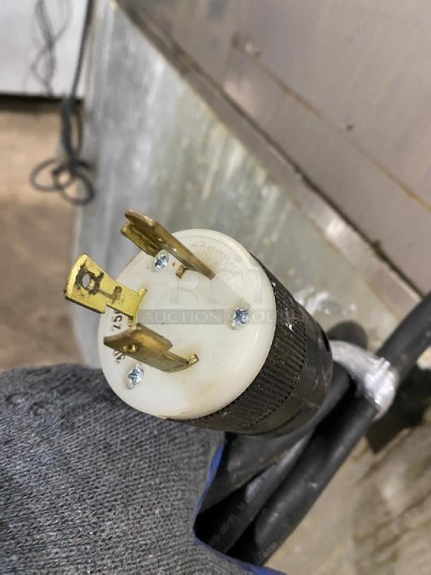 Close-up of a power plug for Kold-Draft GB561AC ice maker, showing prongs and sturdy black cable.