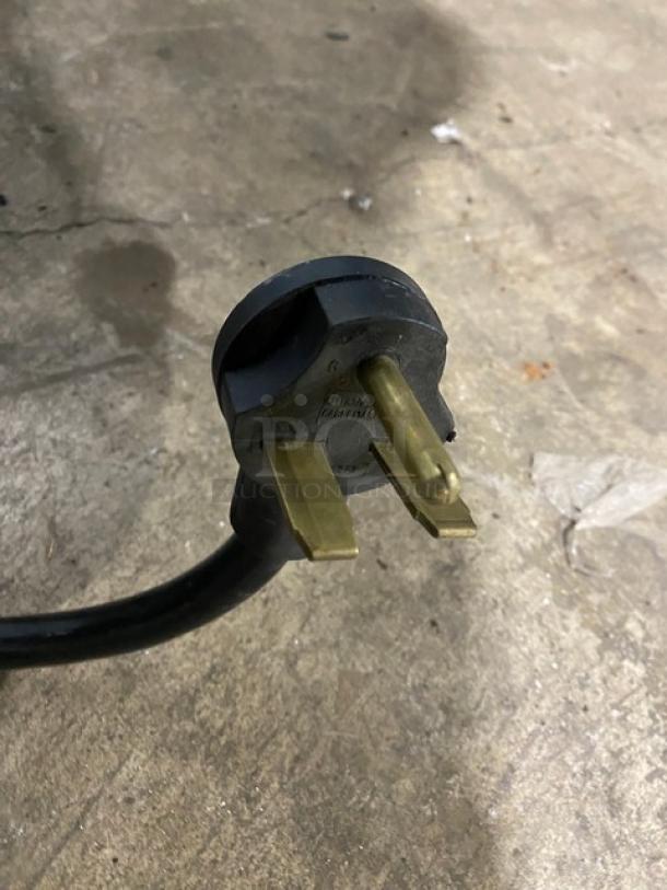 Close-up of a power plug from an Alto-Shaam Vector-H Series oven, model VMC-H2, showing three prongs.