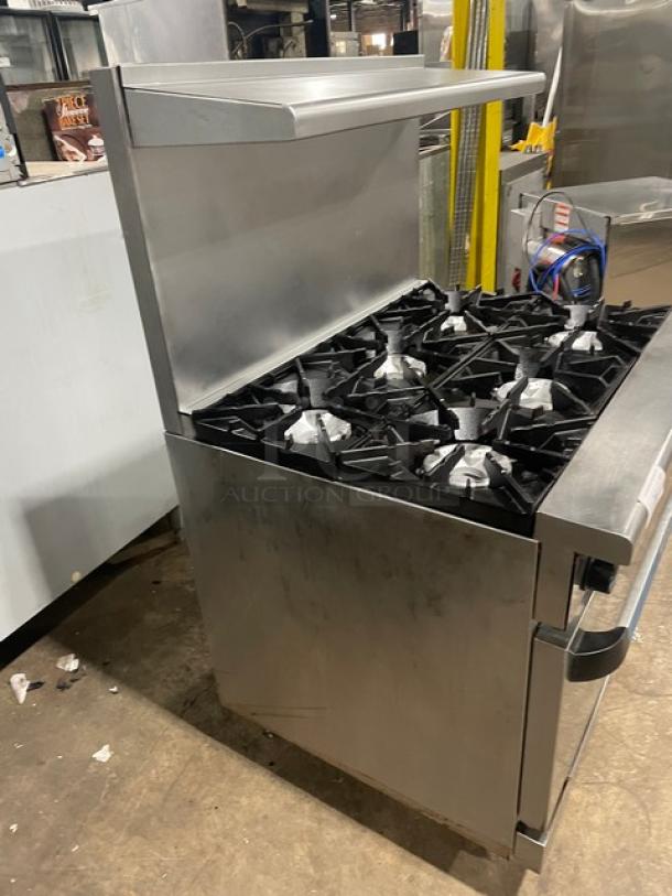 Radiance stainless steel 6-burner gas range/oven combo, featuring backsplash, overhead salamander shelf, and wired oven rack.