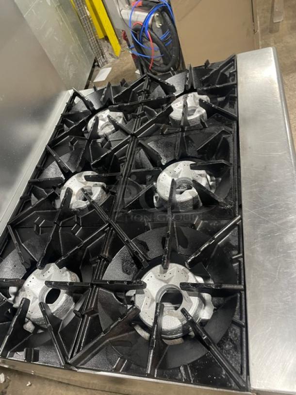 Radiance by Turbo Air 6-burner gas range with stainless steel construction, backsplash, salamander shelf, and wired oven rack.