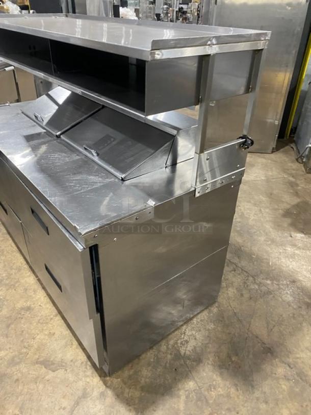 Delfield stainless steel 4-drawer refrigerated salad/sandwich prep table, model UCD4464N12DD5, with enclosed overhead shelf.
