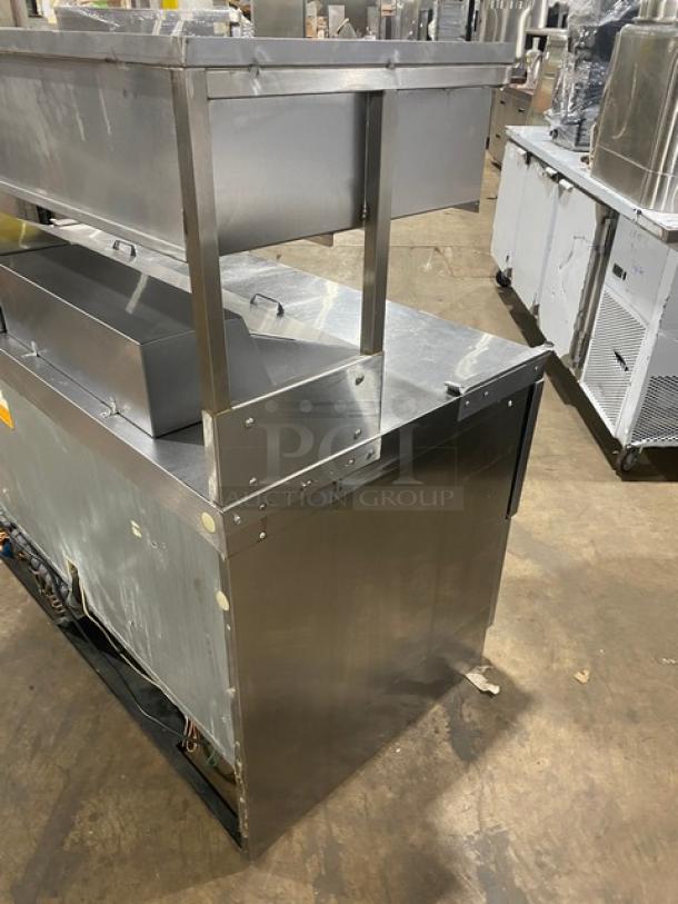 Delfield stainless steel 4 drawer refrigerated prep table, Model UCD4464N12DD5, with overhead shelf, 115V, good condition.