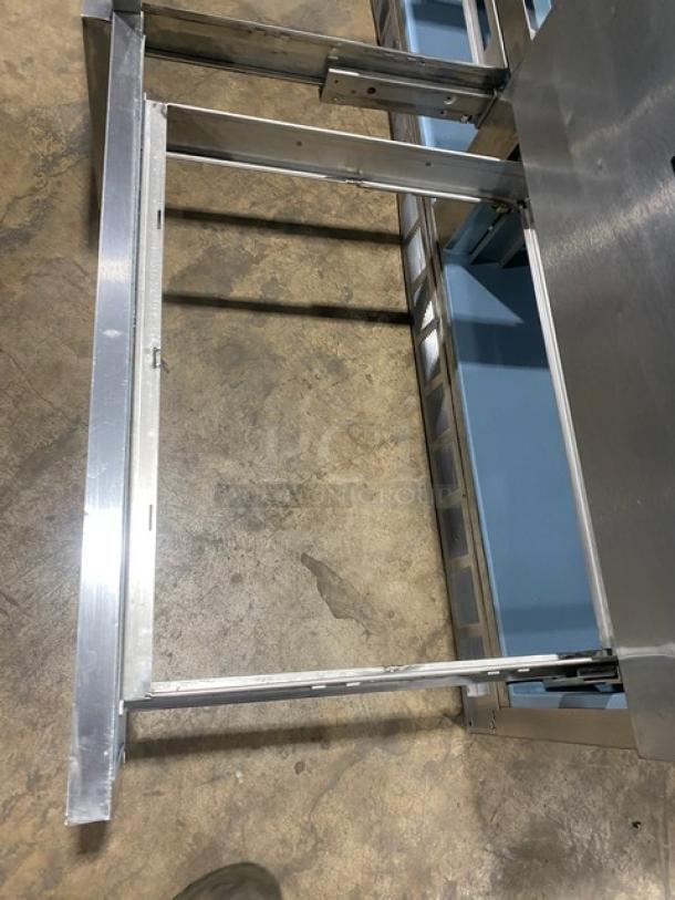 Delfield 4-drawer refrigerated prep table, model UCD4464N12DD5, stainless steel, overhead shelf, auction image.