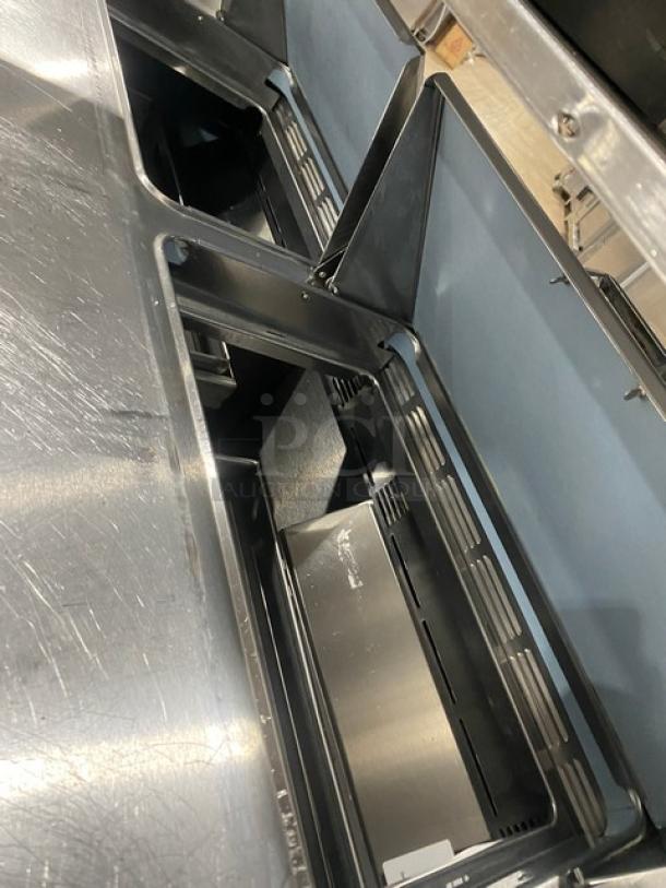 Delfield stainless steel 4-drawer refrigerated prep table, model UCD4464N-12-DD5, with overhead shelf, in good condition.