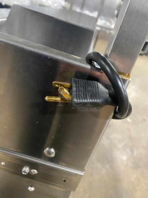 Delfield refrigerated prep table plug, model UCD4464N12DD5, 115V 1 phase, stainless steel, close-up of power cord.