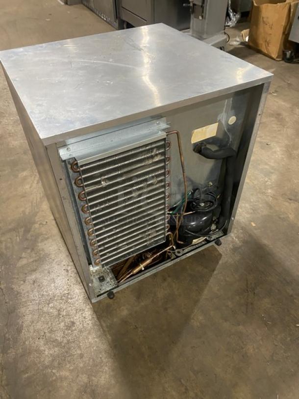 Delfield Enodis Series stainless steel single door undercounter refrigerator, Model 406CADD1, showing back with coil exposed.