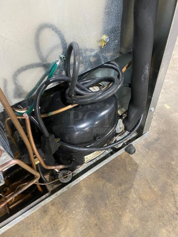 Delfield Enodis 406CADD1 undercounter refrigerator compressor view, poly-coated rack, stainless steel, on casters, 115V.