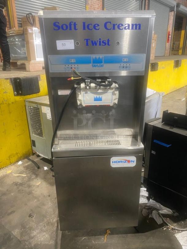 Taylor 8756P-27 soft serve machine, stainless steel, 3 dispensers, Horizon Pump, 208-230V, on casters, good condition.