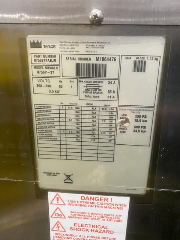 Taylor 8756P-27 stainless steel soft serve machine label, showing model, serial number M1064476, and safety warnings.