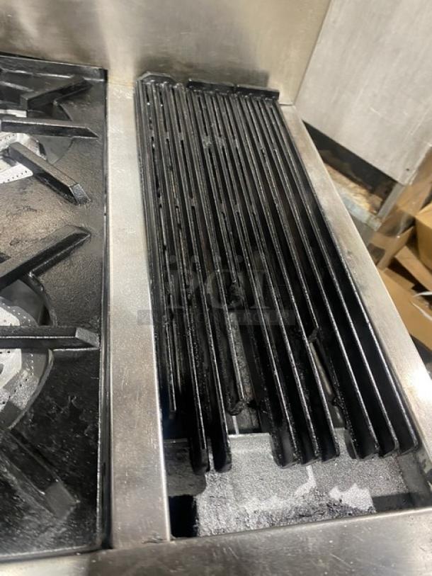 Jade Range stainless steel gas-powered 4-burner char broiler range/oven combo with split top, wired oven rack, and back splash.