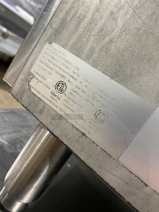 Cookline CHP244 stainless steel natural gas 4-burner hot plate with undershelf stand, serial number 2502110275, on legs.