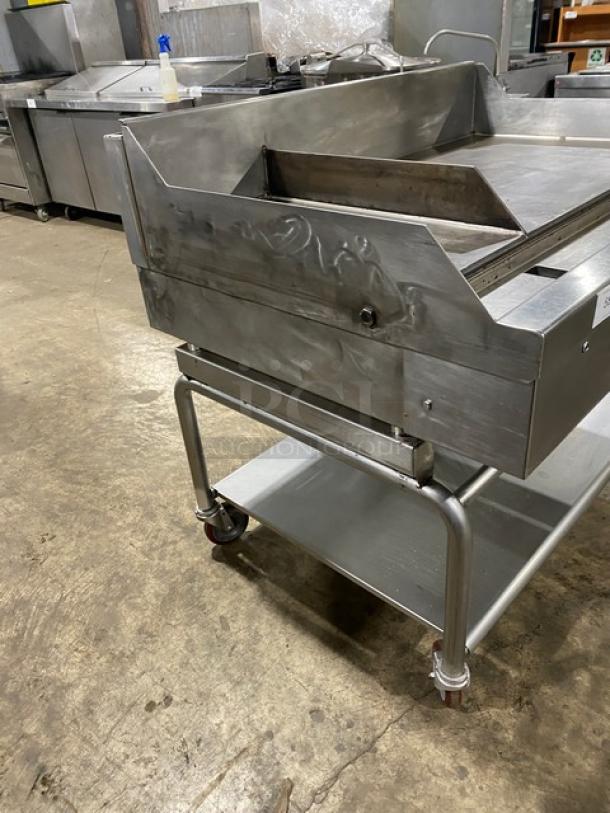 WoodStone 48" stainless steel gas griddle, model WSPL48364CT00NG, with backsplash, undershelf, and caster wheels.