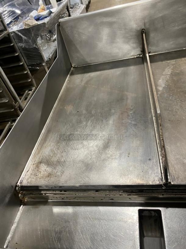 WoodStone stainless steel gas-powered 48" griddle, model WSPL48364CT00NG, with back/side splash, undershelf, on casters.