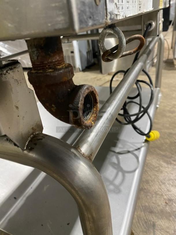 WoodStone stainless steel gas griddle model WSPL48364CT00NG with undershelf cart, visible rust on gas connector, on casters.