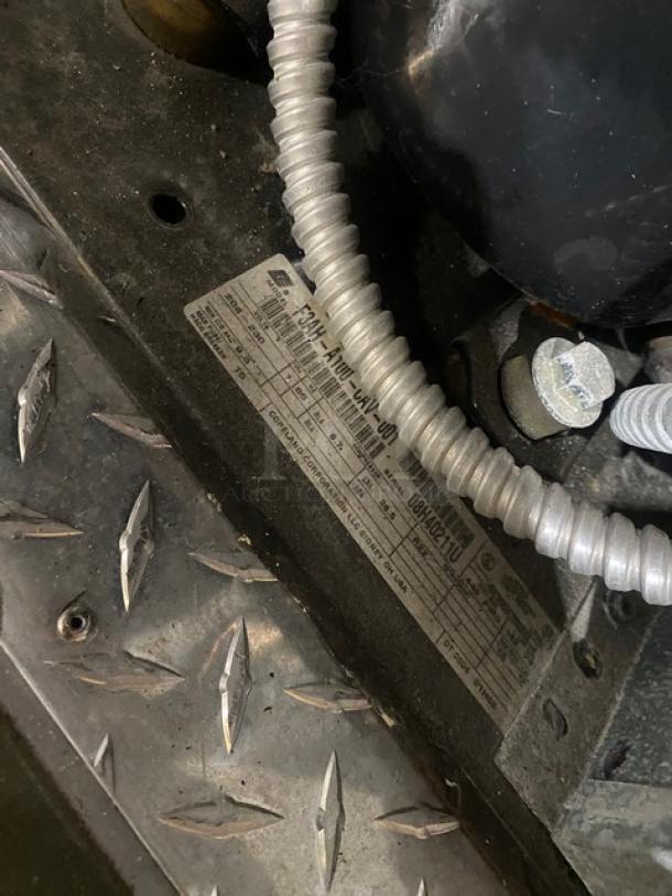 Commercial 5'x9' walk-in cooler box with Copeland condensing unit. Includes visible manufacturer label with specs. Heavy-duty condition.