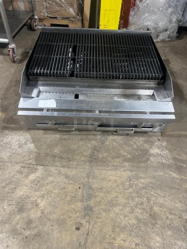 Commercial stainless steel gas-powered countertop char broiler, used condition, features dual control knobs and heavy-duty grates.