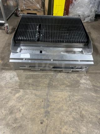 Commercial stainless steel gas-powered countertop char broiler, used condition, features dual control knobs and heavy-duty grates.