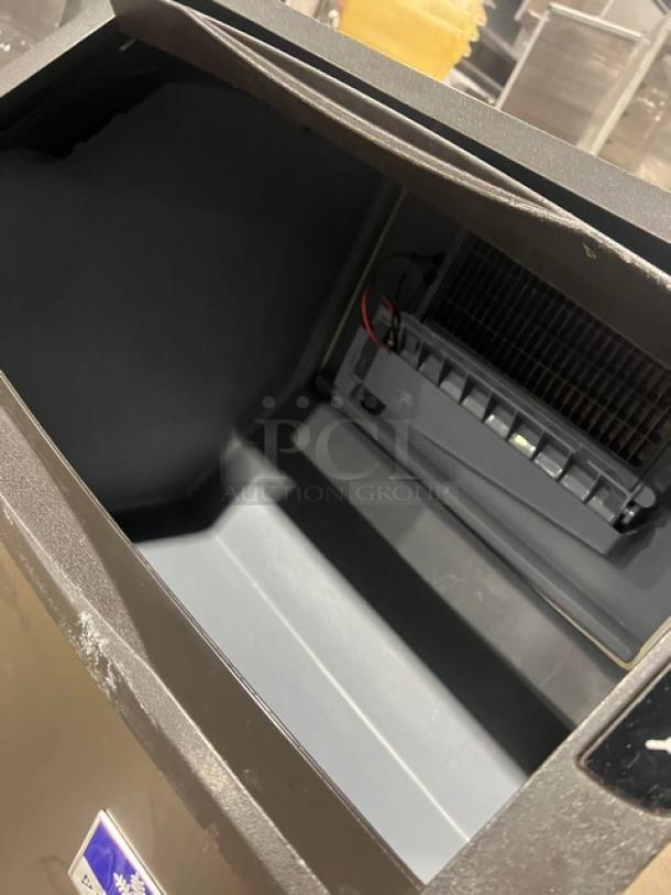 Manitowoc NEO UYF0140A-161B ice machine interior, stainless steel, clean condition, model label visible.