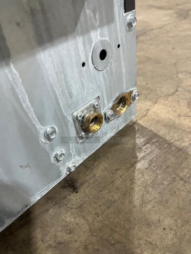 Manitowoc NEO Series ice machine back view, showing connection ports. Model UYF0140A-161B, stainless steel, good condition.