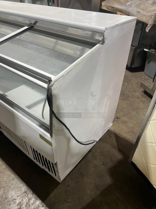 Hussmann LBN8 commercial 96" ice cream display freezer, white, with 4 glass sliding doors, SN: MY11B004683, in good condition.