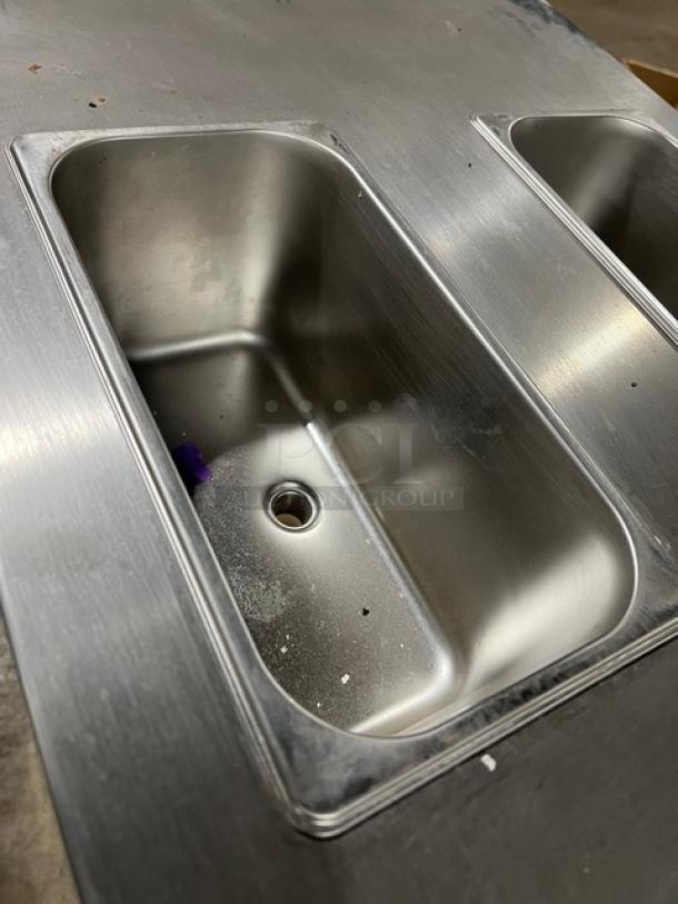 Stainless steel twin soft serve machine, Model XY-25L, showcasing interior compartment, on casters, working condition.