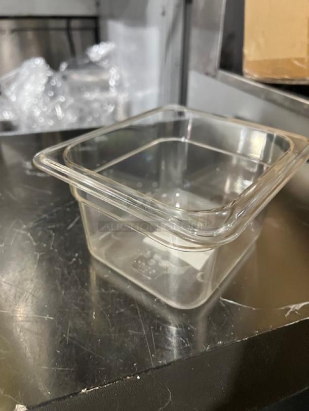 Winco SP7604 clear polycarbonate food pan, 1/6-size, 4" deep, new condition, suitable for commercial use.