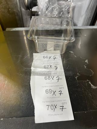 Winco SP7604 clear polycarbonate food pan, 1/6-size, 4" deep, new condition. Includes auction bidding sheet.