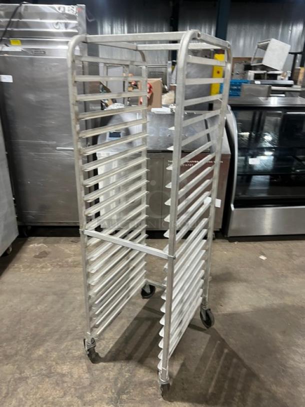 Commercial aluminum full-height bun/sheet pan rack on casters, multiple slots, sturdy construction, used condition.
