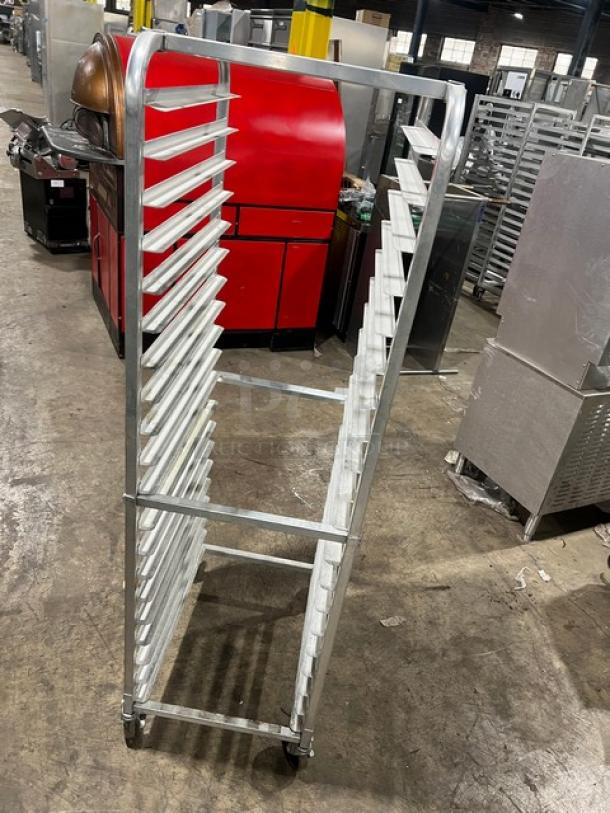Commercial full-height aluminum bun/sheet pan rack on casters, excellent condition, multiple slots for storage, ideal for bakeries.