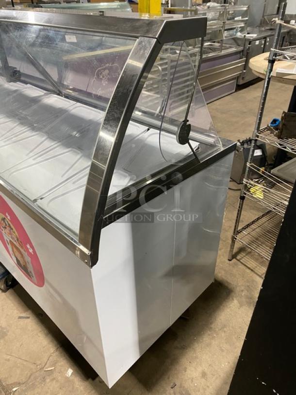 Global Baskin-Robbins style commercial ice cream cabinet with sneeze guard, dual rear access doors, and covers.