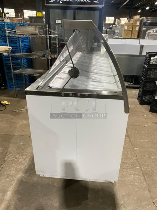 Global Baskin Robbins-style ice cream dipping cabinet with sneeze guard, dual rear access doors, covers, and tub holders.