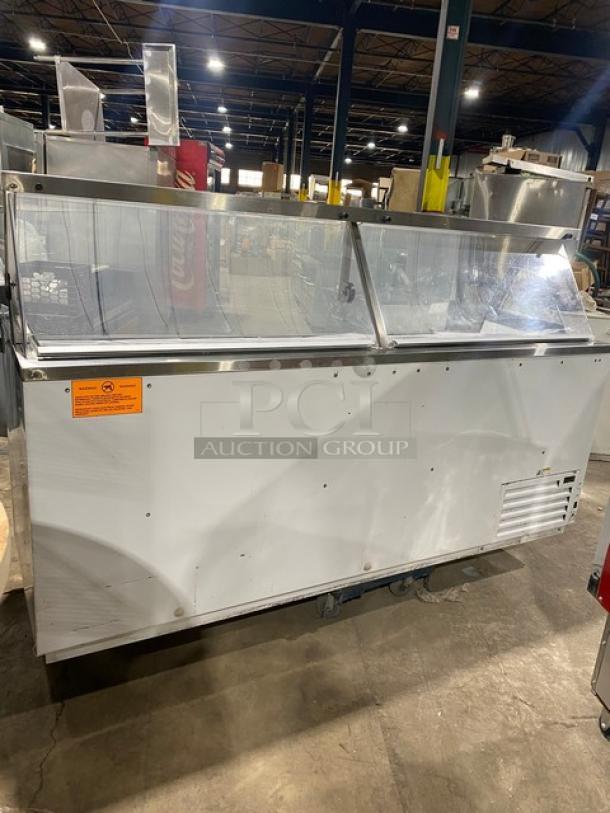Global Baskin Robbins style ice cream cabinet with sneeze guard, dual rear doors, covers, and tub holders. Used condition.