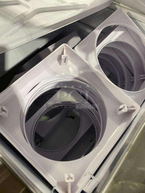 Global Baskin Robbins-style ice cream cabinet interior showing tub holders and accessories, with sneeze guard and rear access.